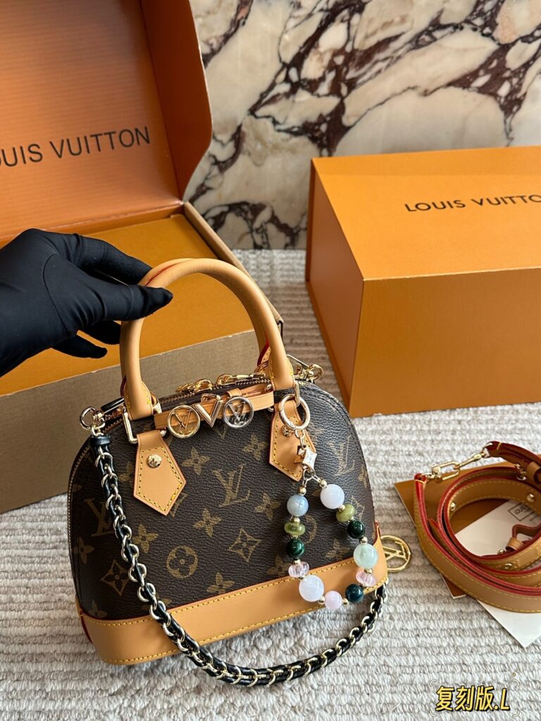 Louis Vuitton Alma Gold Leather Handbag editorial product context 1